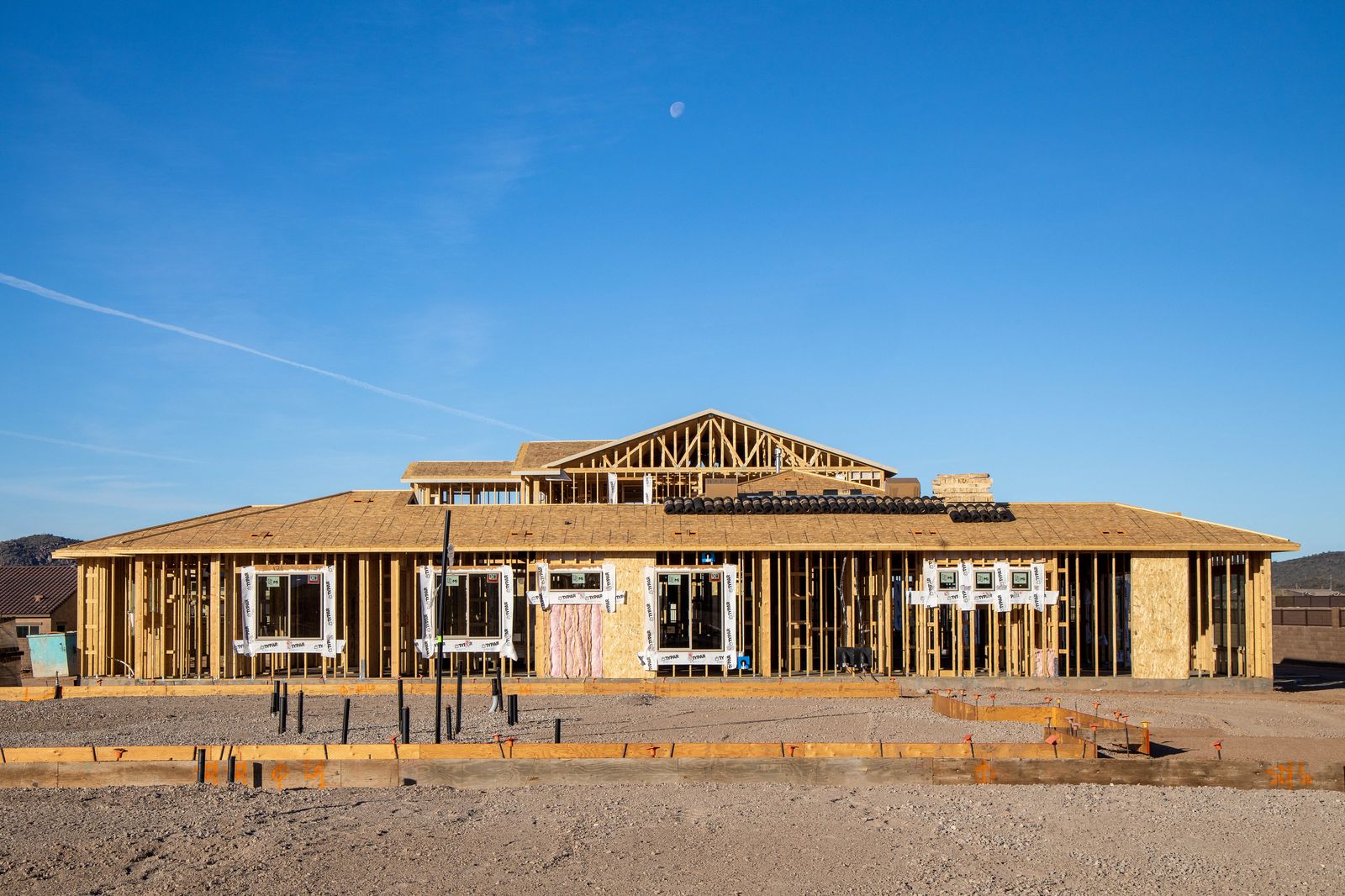 Sprawling ranch with moon in blue sky